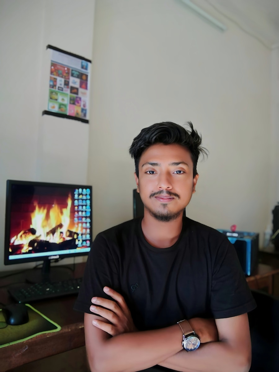 A man sitting in front of a computer monitor